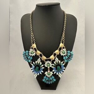 Statement necklace in gold tone with blue and green stones